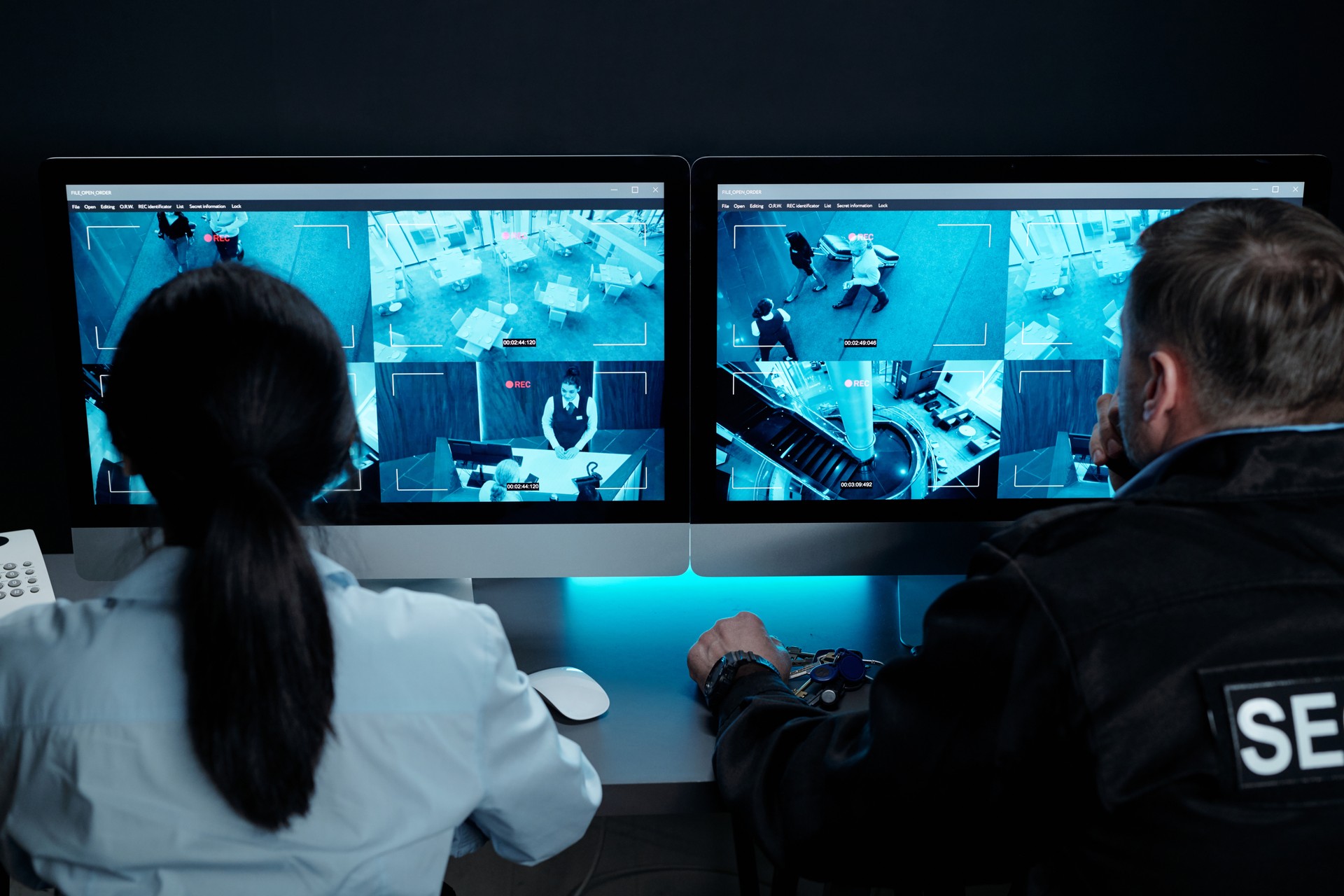 Two officers watching cctv video cameras